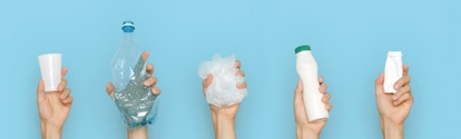 Concept of garbage sorting and ecology. Photo for website banner. Hands holding different trash on a blue background.